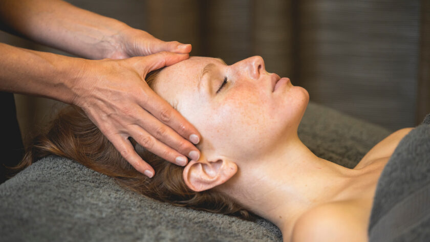 Guest enjoys a soothing head massage at luxury hotel spa, promoting relaxation and rejuvenation.
